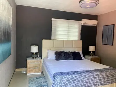 a bedroom with a bed and two night stands with lamps at El Paso Hotel in Arroyo de Agua