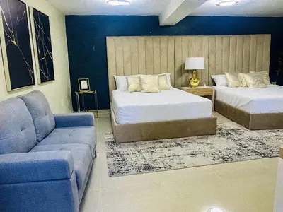 a living room with two beds and a couch at El Paso Hotel in Arroyo de Agua
