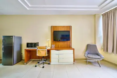 an office with a desk and a tv and a chair at Hotel Libertad at historic main street in Santo Domingo