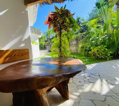 a wooden table sitting on a patio at Casa Blanca - White House in Cabarete