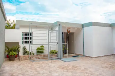a house with a pivot door in a courtyard at D' Yoko Village's in Pedernales