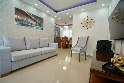 a living room with a couch and a chair at Las vacaciones que soñaste en un lugar seguro! in Santiago de los Caballeros