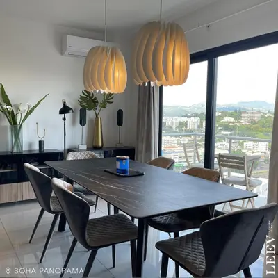 a dining room with a table and chairs and lights at Soha panorama- A14- 2 dormitorios in Santiago de los Caballeros