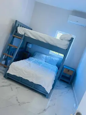 a blue room with a bunk bed in a room at The Green Palms 5 Bedroom villa with pool / garden in San Felipe de Puerto Plata
