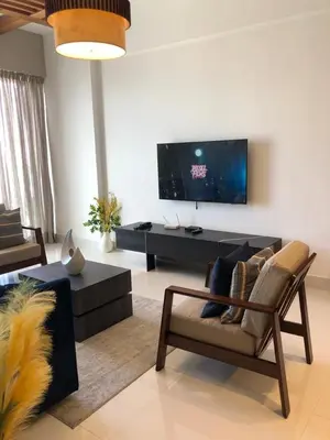 a living room with a couch and a tv at Piantini’s Skylight in Santo Domingo