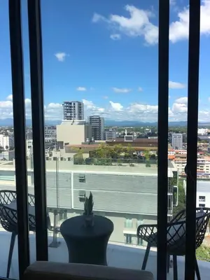 a view of a city from a window with two chairs at Piantini’s Skylight in Santo Domingo