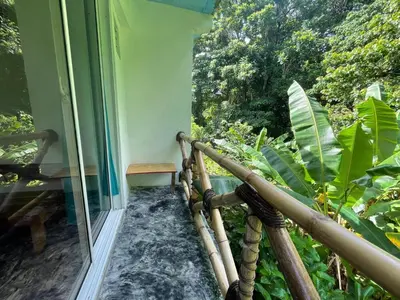 a balcony with a view of a forest at Salvaje Rooms&Restaurant in Santa Bárbara de Samaná