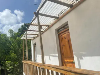 a porch with a pergola and a wooden door at Salvaje Rooms&Restaurant in Santa Bárbara de Samaná