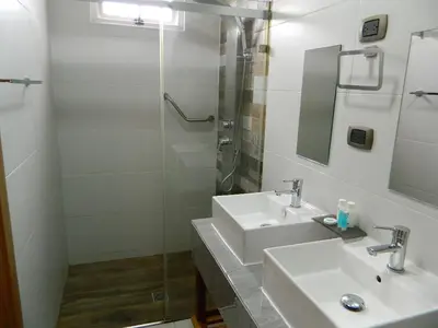 a bathroom with two sinks and a shower at N1001 Gran vista Downtown Santo Domingo RD in Santo Domingo