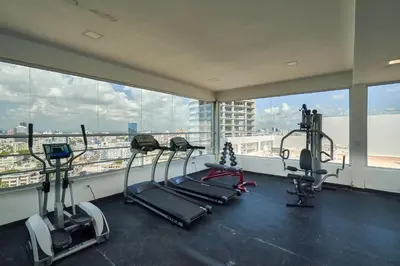 a gym with cardio equipment in a large room with windows at N1001 Gran vista Downtown Santo Domingo RD in Santo Domingo