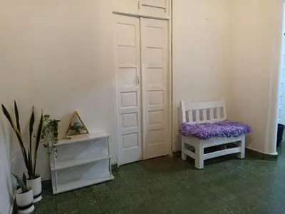 a white door with a bench with a purple seat at La casa de Isabel y Juan, Zona Colonial in Santo Domingo