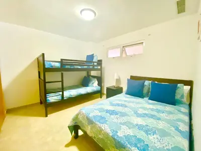 a bedroom with a bed and a bunk bed at 703 Marbella 2 bedrooms Beachfront Beautiful Apartment in San Pedro de Macorís