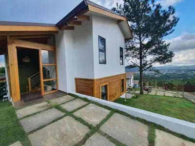 a small house with a view of a hill at Villa en la montaña in Jarabacoa