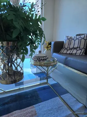 a living room with a couch and a glass table at Madome Aparta Hotel in Pedernales