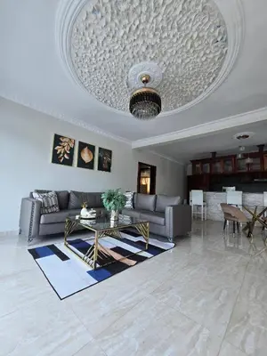 a living room with a couch and a table at Madome Aparta Hotel in Pedernales