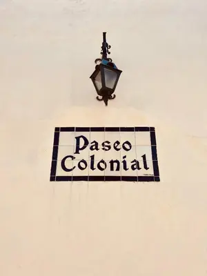 a sign on the side of a building with a street light at Paseo Colonial - Sabbatical #1 in Santo Domingo