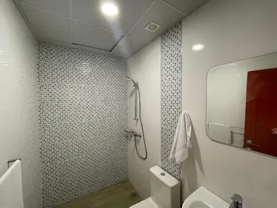 a bathroom with a shower and a toilet and a sink at Hotel Conquistador Santo Domingo in Santo Domingo