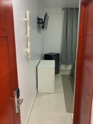 a hallway with a white cabinet in a room at Hotel Conquistador Santo Domingo in Santo Domingo