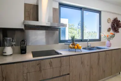 a kitchen with a counter with a sink and a window at Beachfront penthouse - Amar'e Aparthotel & Spa in Las Terrenas