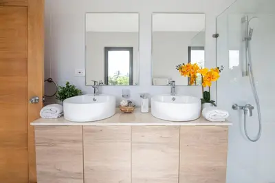 two sinks in a bathroom with two mirrors at Beachfront penthouse - Amar'e Aparthotel & Spa in Las Terrenas