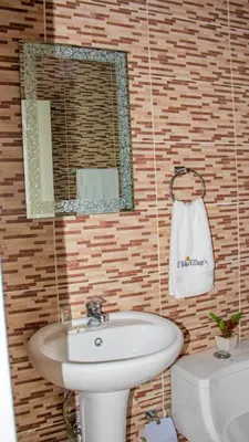 a bathroom with a sink and a mirror and a toilet at D´ Yoko Village´s in Pedernales