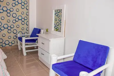 a room with two chairs and a dresser and a mirror at D´ Yoko Village´s in Pedernales