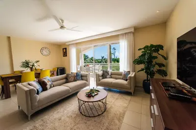a living room with two couches and a table at Special Offer, Iberostar Apartment Milagro 3BDR Pool, Beach in Punta Cana