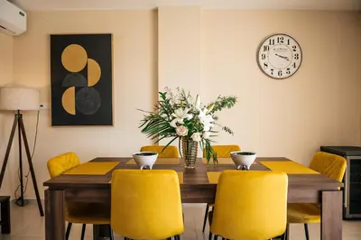 a dining room with a wooden table and yellow chairs at Special Offer, Iberostar Apartment Milagro 3BDR Pool, Beach in Punta Cana