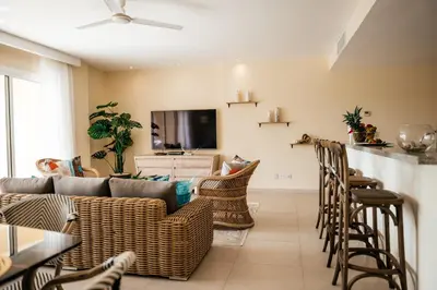 a living room with a couch and chairs at Spacious Iberosta ApartmentSueno - 3BDR Pool, Beach, WiFi in Punta Cana