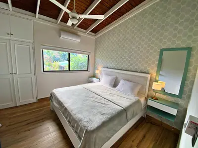 a bedroom with a large bed and a window at Beach Apartment Villas Jubey, Emotion access in Juan Dolio