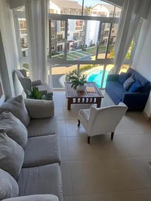 a living room with a couch and chairs and a table at Armonia De Las Terrenas Gorgeous Penthouse in Las Terrenas