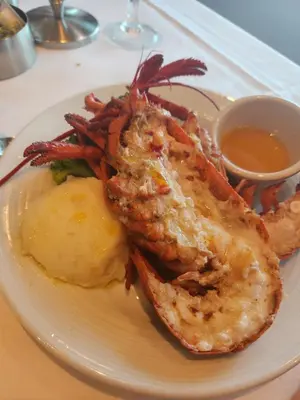 a plate of food with shrimp and potatoes and sauce at Full size 2 bedrooom 2 bath condo split in Sosúa