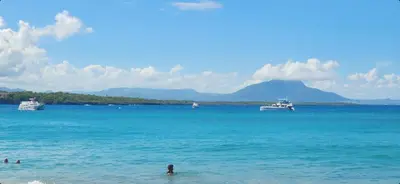 a group of boats in the water on a beach at Full size 2 bedrooom 2 bath condo split in Sosúa