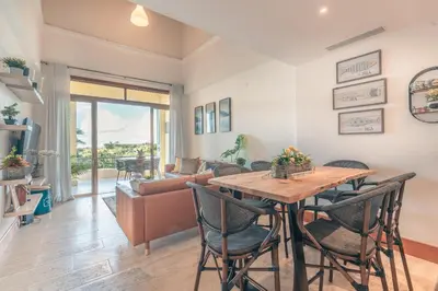 a living room with a table and chairs and a couch at Wonderful Apt at Casa de Campo in El Infiernito