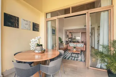 a living room with a wooden table and chairs at Wonderful Apt at Casa de Campo in El Infiernito