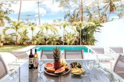 a glass table with a plate of food and wine at 3 Bedroom Pool Villa 50M To The Beach in Las Terrenas