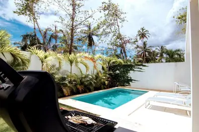 a barbecue grill next to a swimming pool at 3 Bedroom Pool Villa 50M To The Beach in Las Terrenas