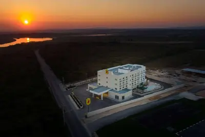 an overhead view of a building with the sunset in the background at Super 8 by Wyndham Manzanillo in Pepillo Salcedo