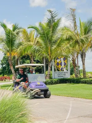 a man riding a purple golf cart at Golf & Lake View Oasis •Private Jacuzzi •Hard Rock in Punta Cana