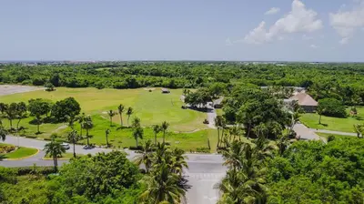 an aerial view of a golf course with palm trees at Golf & Lake View Oasis •Private Jacuzzi •Hard Rock in Punta Cana