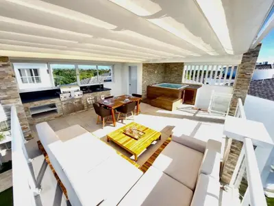 a living room with white furniture and a table at Golf & Lake View Oasis •Private Jacuzzi •Hard Rock in Punta Cana