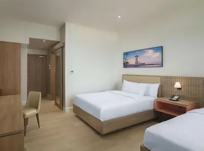 a hotel room with a bed and a desk and a chair at Hilton Garden Inn La Romana in La Romana