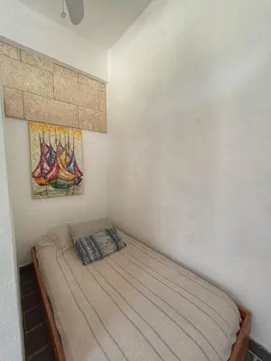 a bed in a bedroom with a painting on the wall at Marina Bay in Las Terrenas