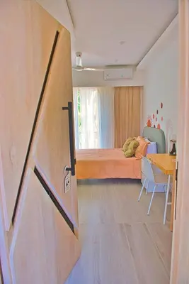 a bedroom with a bed and a table and a door at Marina Bay in Las Terrenas
