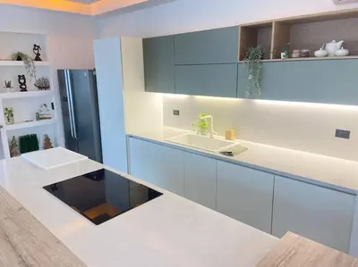 a kitchen with blue and white cabinets and a sink at Marina Bay in Las Terrenas