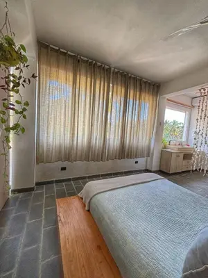 a bedroom with a large bed and a large window at Marina Bay in Las Terrenas