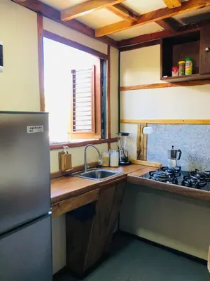 a kitchen with a sink and a stove at Rustic House Punta Rucia in Punta Rucia