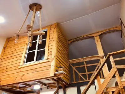 a room with wooden walls and a chandelier at Rustic House Punta Rucia in Punta Rucia