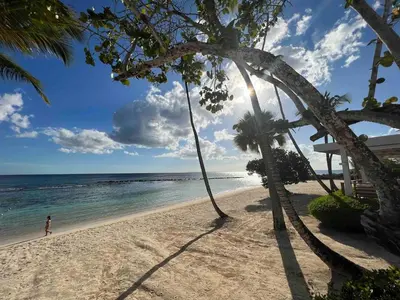 a person walking on a beach near the ocean at Fontana di Rosa, African Style Villa Casa de Campo in La Romana