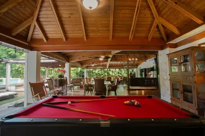 a pool table in the middle of a living room at Fontana di Rosa, African Style Villa Casa de Campo in La Romana